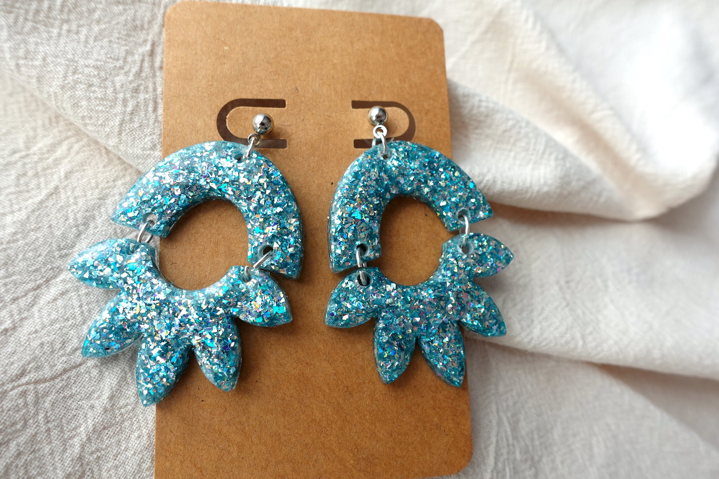 Halve bloem oorbellen lichtblauw met holografische glitter - statement oorbellen
